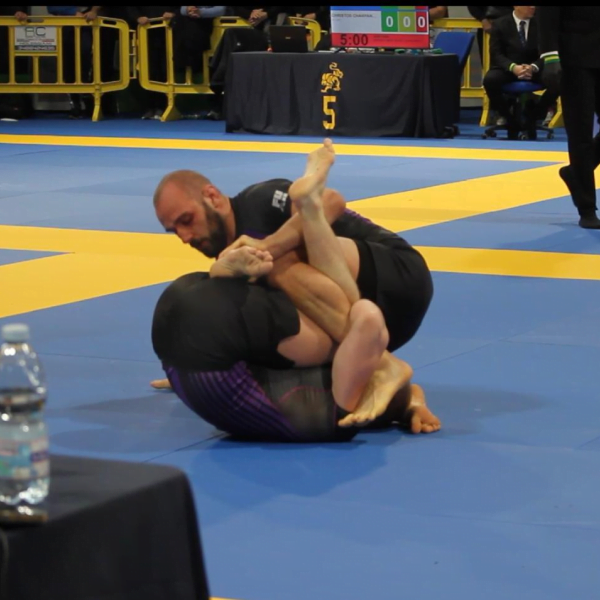 Purple belt Roger Gracie Bristol competitor rolling in a competition match.