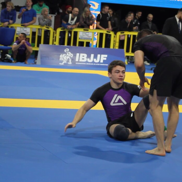 Purple belt male Roger Gracie Bristol competitor in a competition match. Playing guard