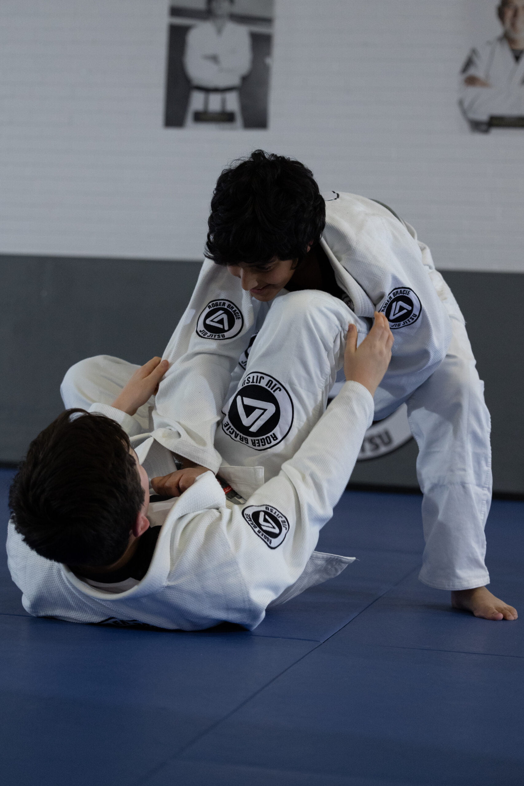 Two Roger Gracie Bristol students sparring. One led down playing guard and the other on top trying to pass the guard.