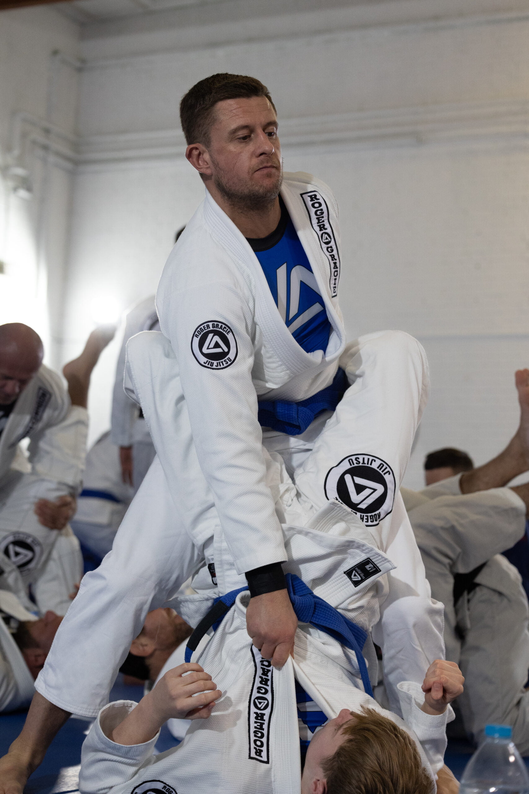 Roger Gracie Bristol blue belt standing up ready to break the closed guard open.