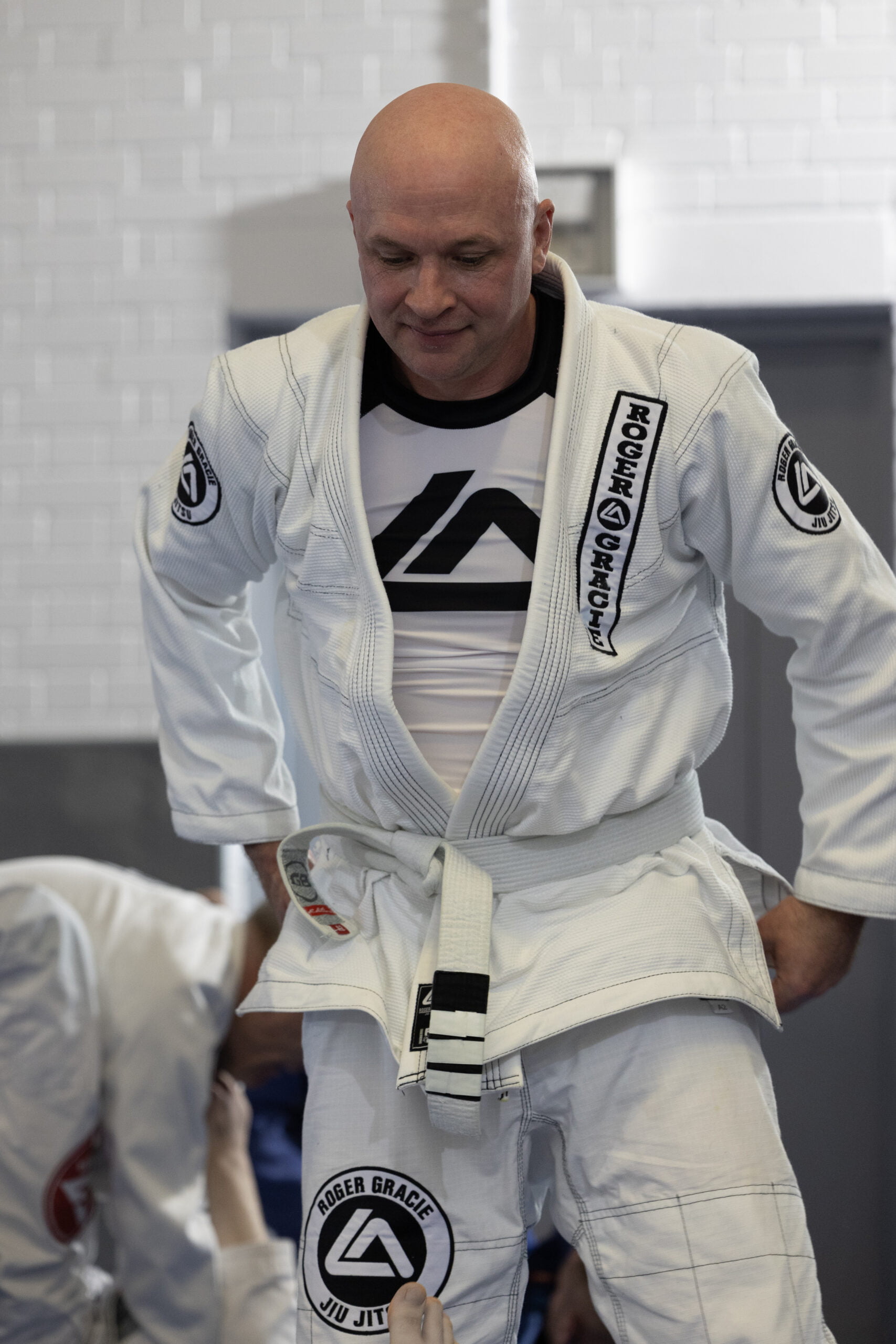 Roger Gracie Bristol white belt adjusting his uniform.